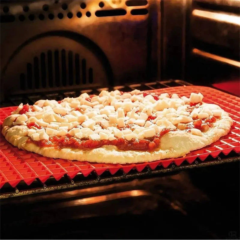 Red non-stick silicone pyramid cooking mat on a baking tray, showing grid pattern and 39.5 cm size