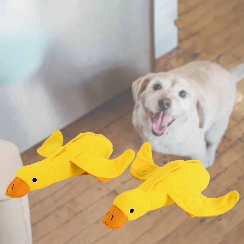 Yellow plush teddy duck dog toy with sound mechanism and treat leak hole for pet training