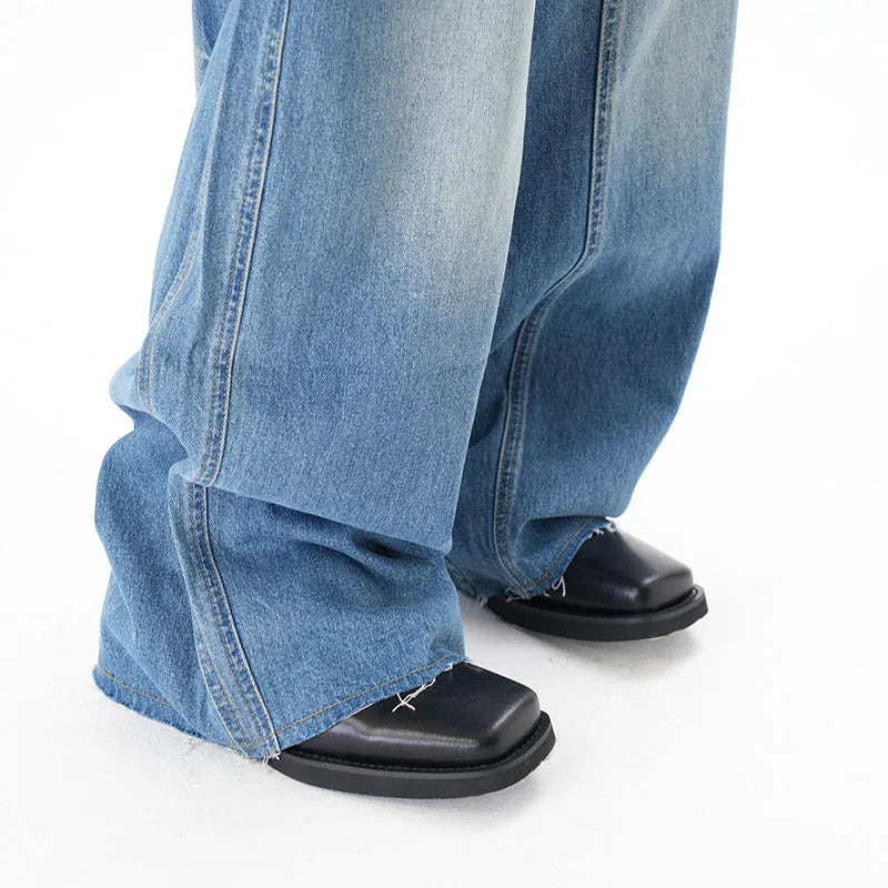 Cut washed vintage washed wide leg machete jeans in light blue denim with zipper fly, front view