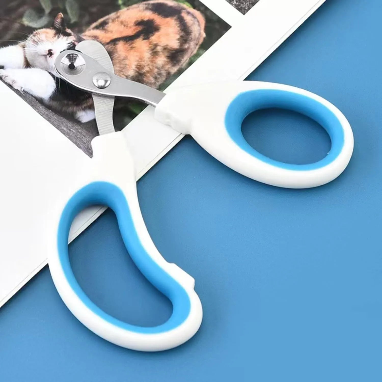 Blue professional pet nail clippers with circular safety hole and non-slip handle.