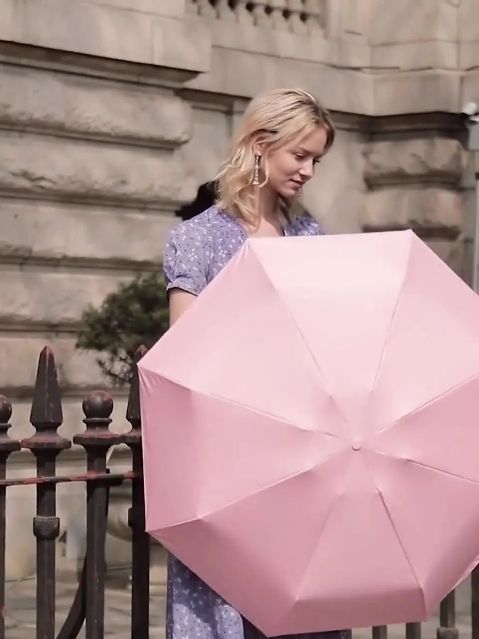 Compact six-fold umbrella in mint green with a capsule box, showing its folded size and rubber handle.