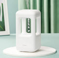 White anti-gravity water drop humidifier with ambient light on bedside table
