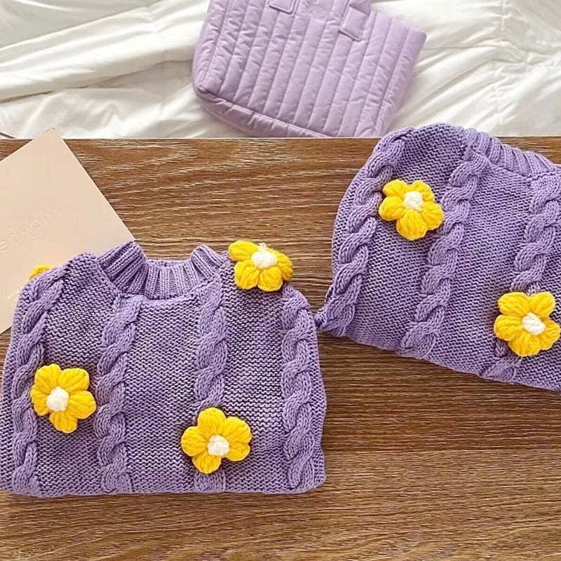 Purple knitted flower print dog clothes with size options from XS to XL on a plain background