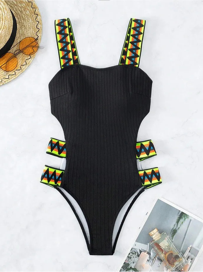 Solid colour women's one-piece polyester swimsuit on a model, available in black and orange.