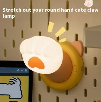 Cat paw rechargeable tap lamp with three brightness levels on a nightstand