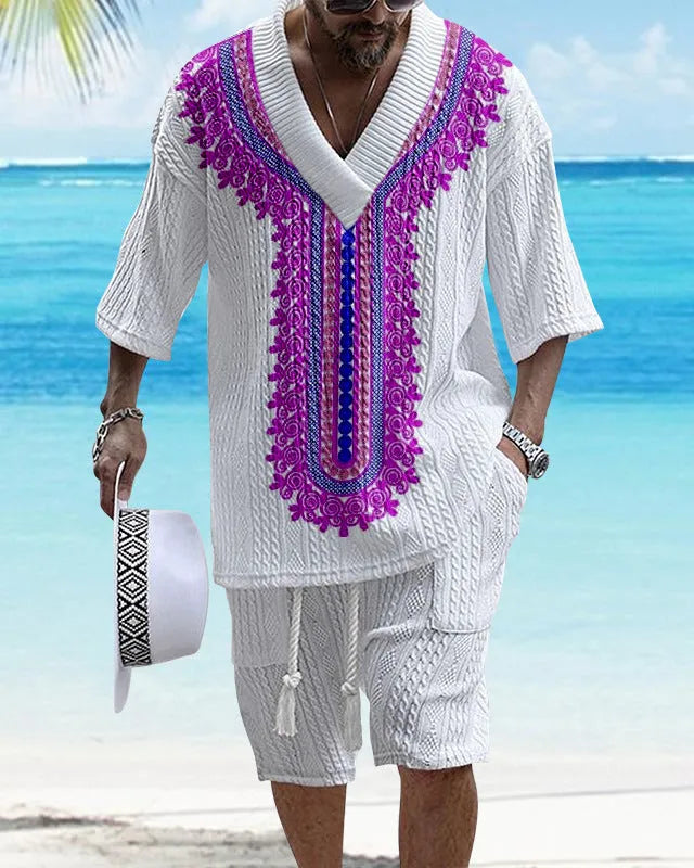 Man wearing a printed drop-shoulder knitted short-sleeved top with matching shorts in a casual setting.