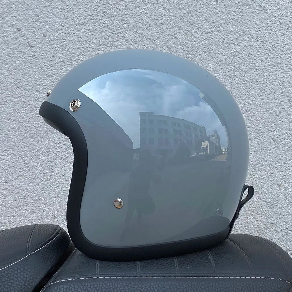 Glass fibre motorcycle half helmet in retro style shown in cement grey colour