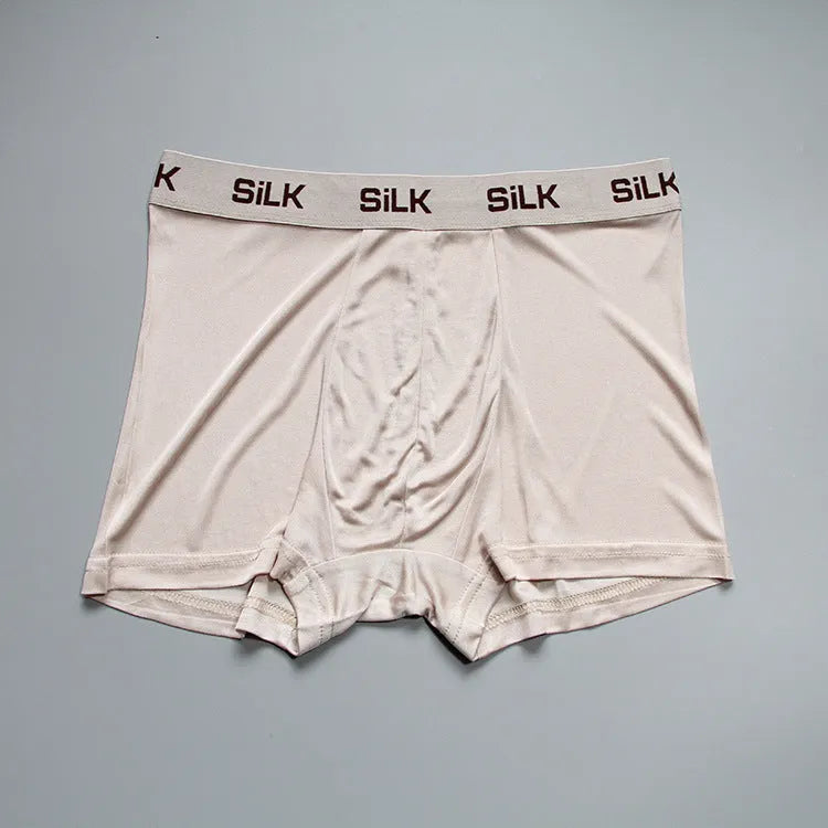 Men's loose fit silk shorts in navy blue, shown on a mid waist.