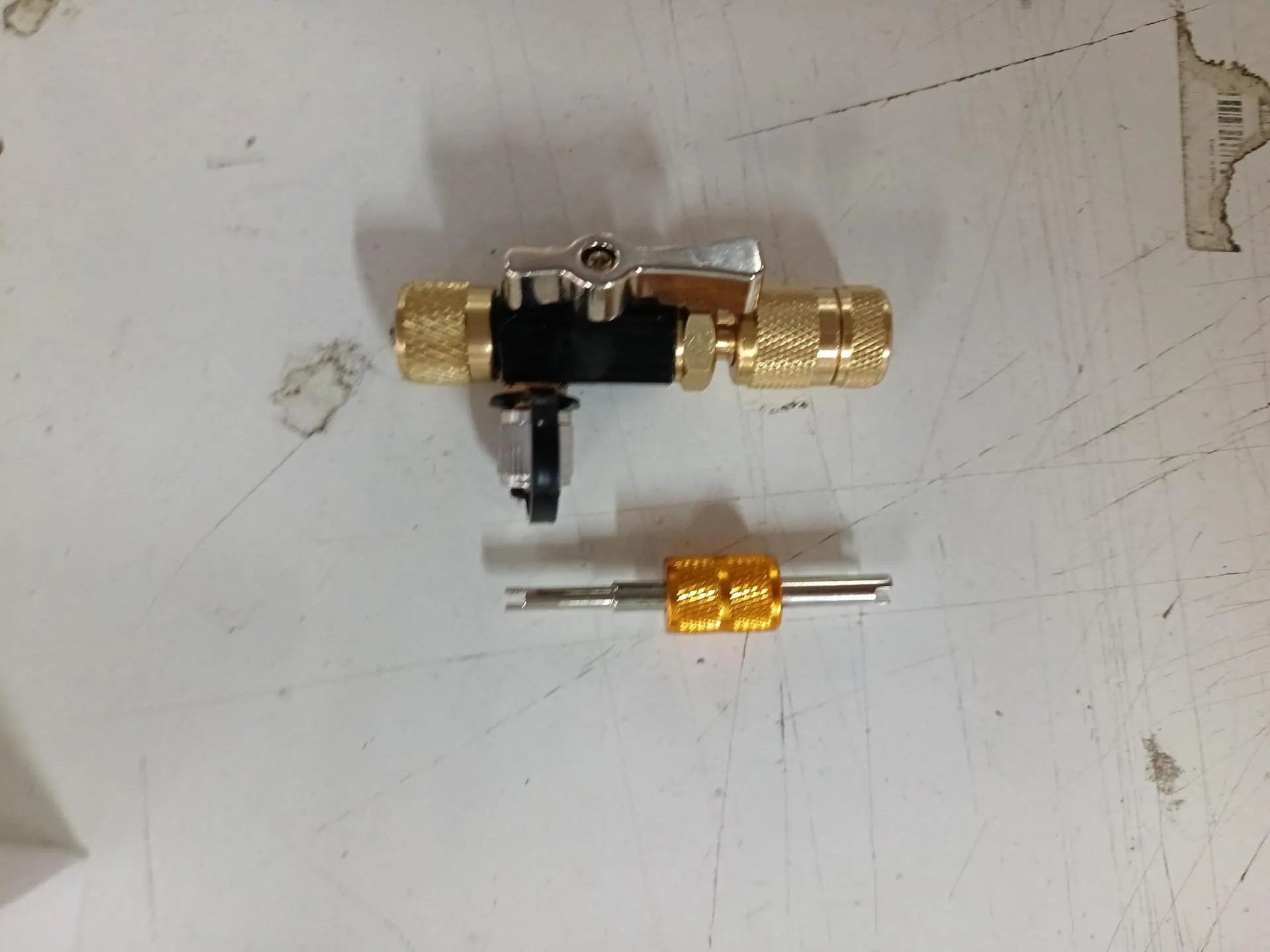 Vacuum valve core disassembly tool set showing metal construction with valve remover and optional wrench