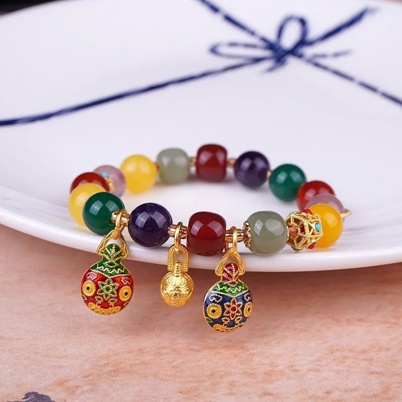 Swallowing Gold Beast agate crystal bracelet with 10mm beads, hand-woven, animal zodiac style on neutral background