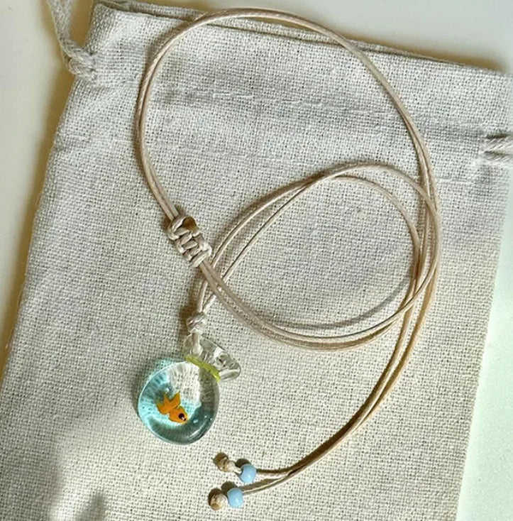 Women's necklace with a coloured glaze Joker pendant wearing a skirt on a cotton and linen chain.