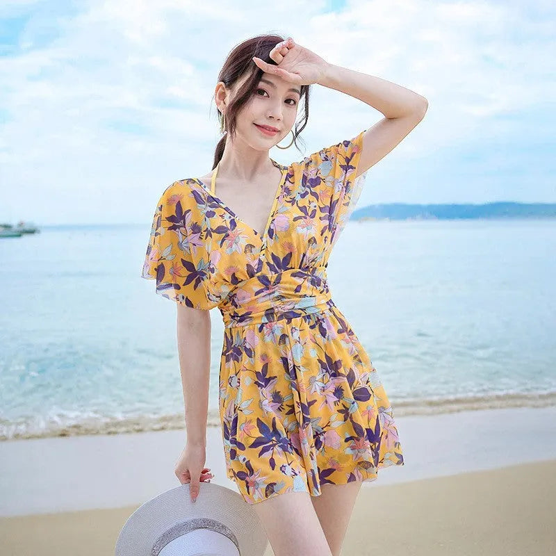 Women's yellow floral one-piece swimsuit with attached skirt, made from polyester, available in multiple sizes