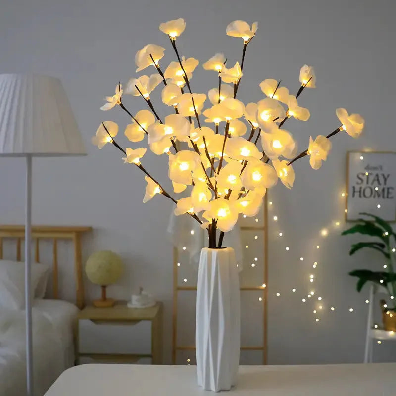 Pink Phalaenopsis branch shaped decorative LED light with 20 warm white lights, powered by batteries.
