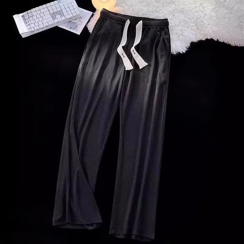 Men's loose straight cotton casual trousers in white, front view, on a model