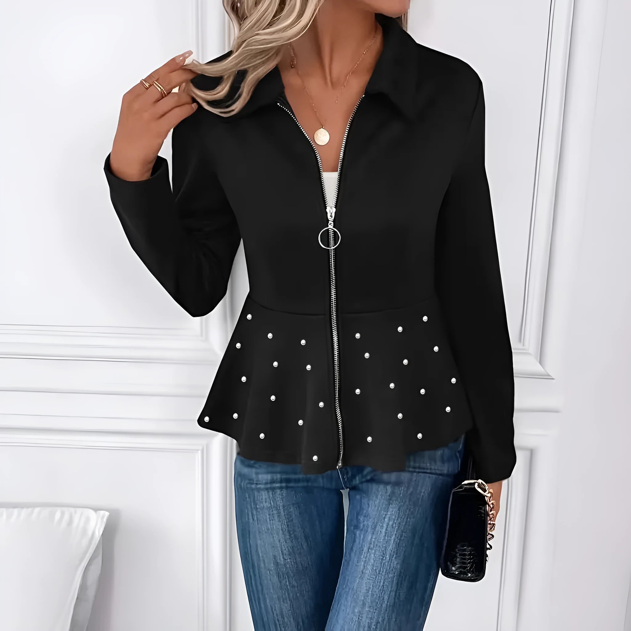 Women's loose black coat with beaded heavy-duty zipper and ruffled hem, shown on a hanger.