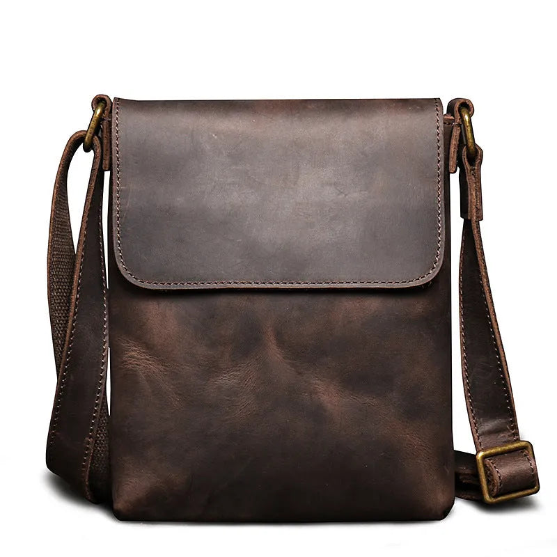 Men's genuine leather messenger bag in retro solid colour black shown on a table