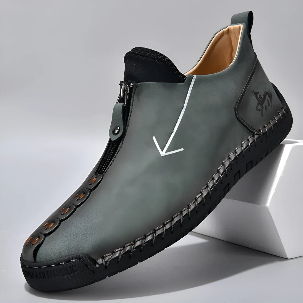 Men's brown leather-look martin boots with a front zipper and round toe on a rubber sole.