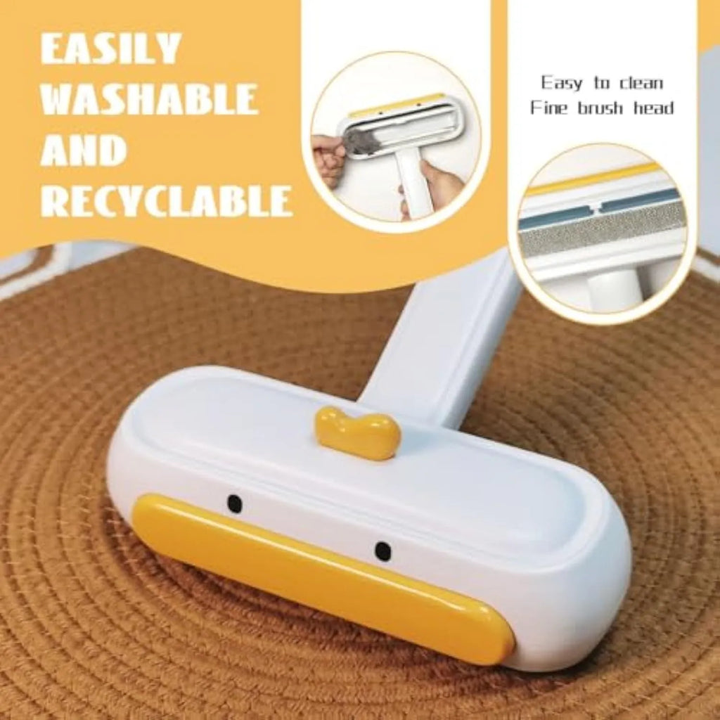 Portable yellow pet hair remover brush with duck design on a fabric sofa.
