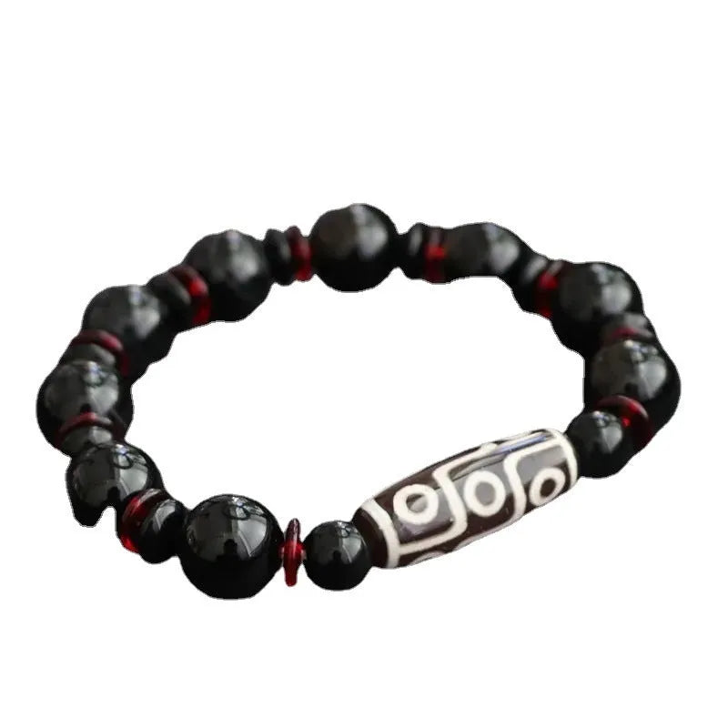 Black agate Dzi bead bracelet with geometric design and hand-woven construction