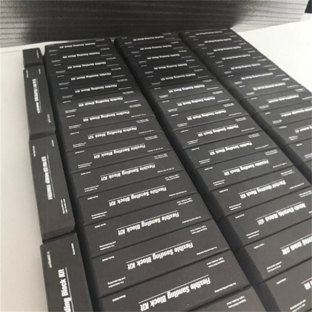 Seven black EVA foam modelling blocks with a frosted texture arranged together.