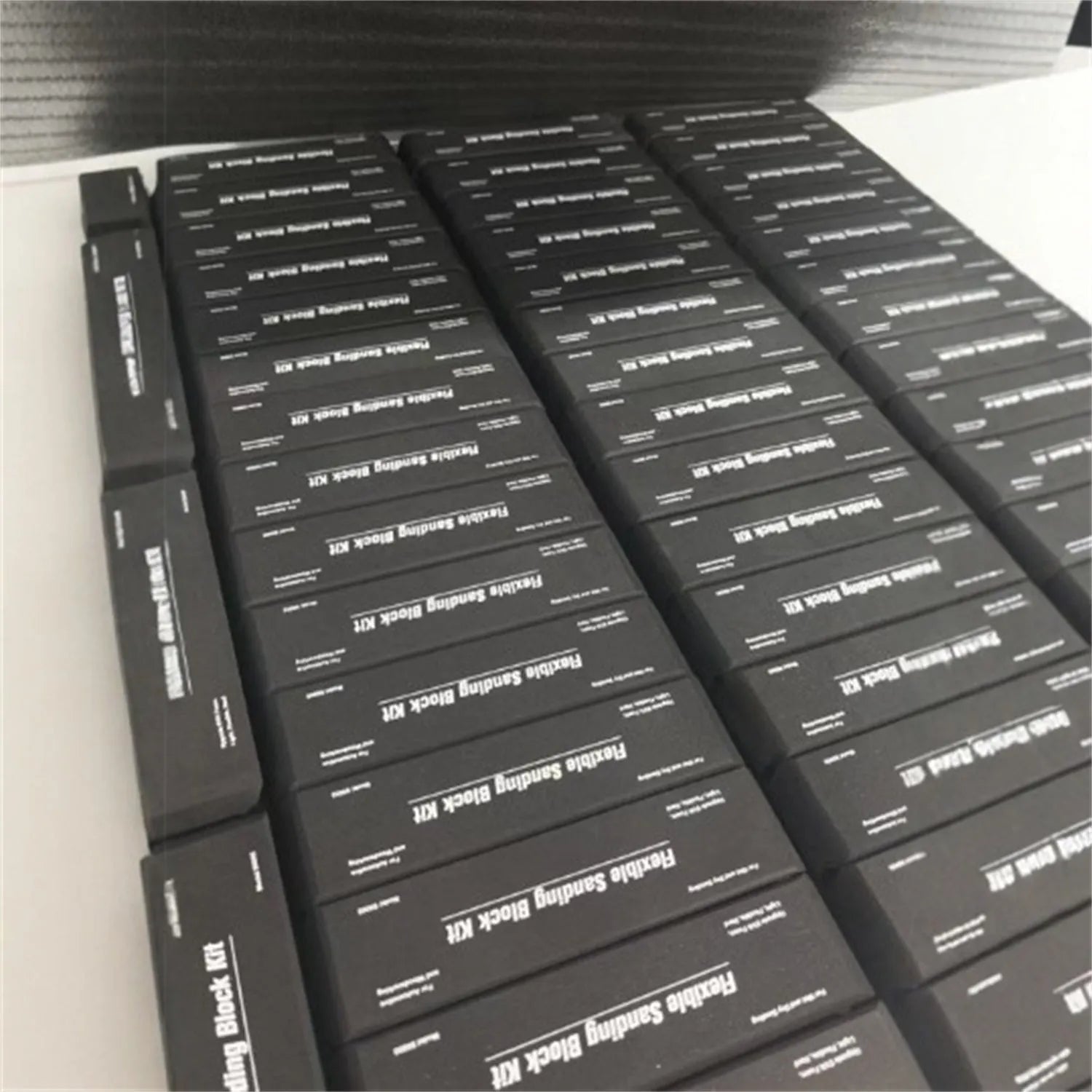 Seven black EVA foam modelling blocks with a frosted texture arranged together.
