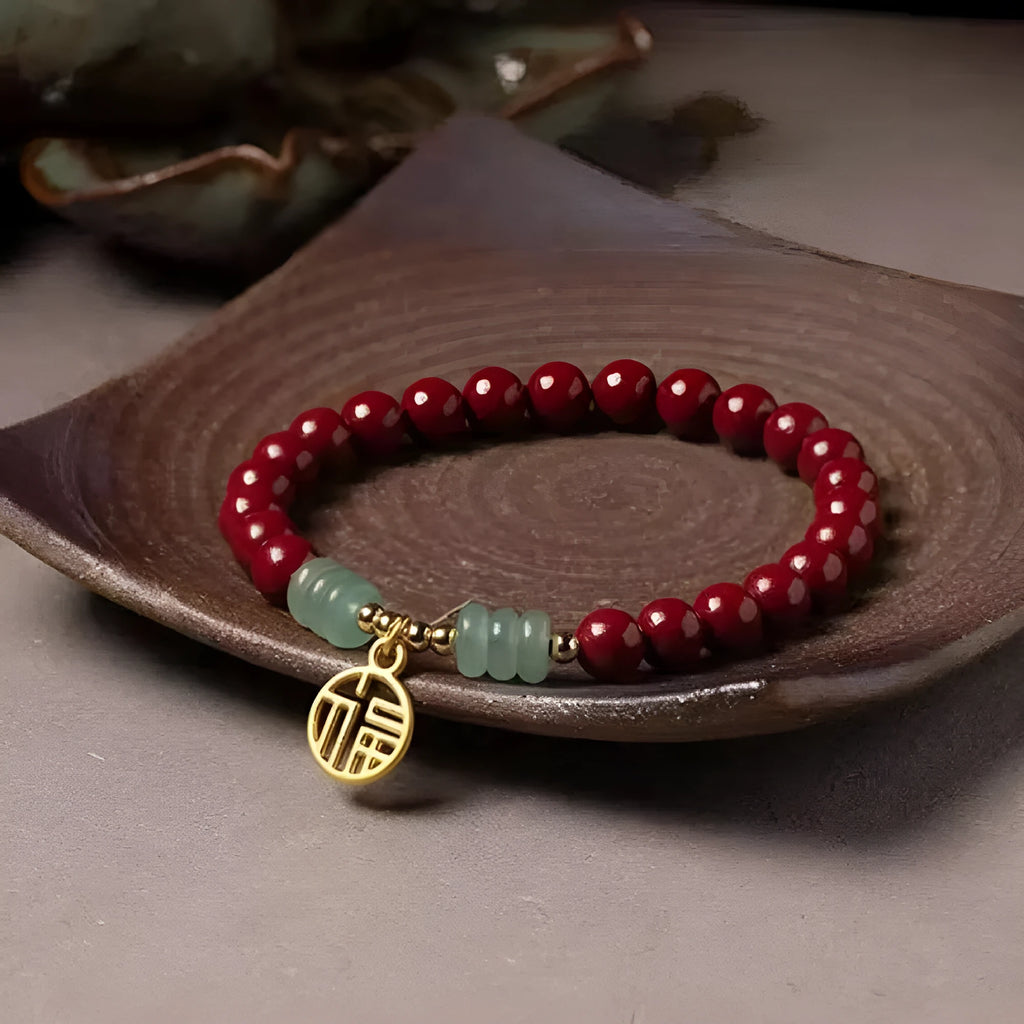 Handmade wave-shaped bracelet featuring cinnabar and copper beads on a wrist.