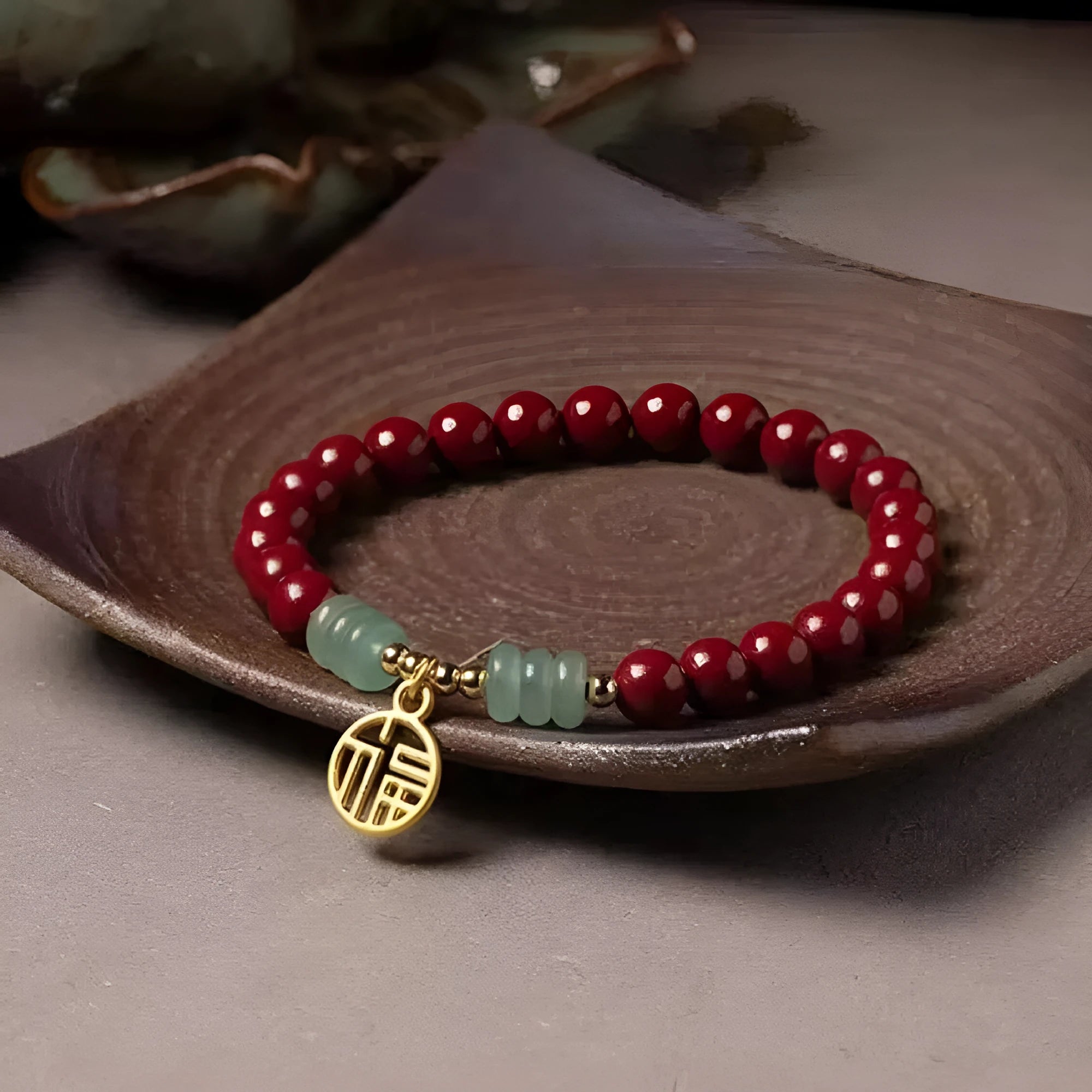 Handmade wave-shaped bracelet featuring cinnabar and copper beads on a wrist.
