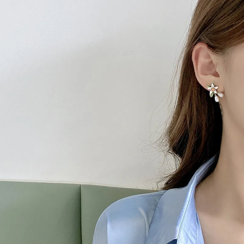Silver colour needle camellia flower earrings showing stud and clip-on styles.