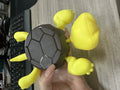 Creative turtle-shaped ABS plastic coaster in one of four colour options on a table.