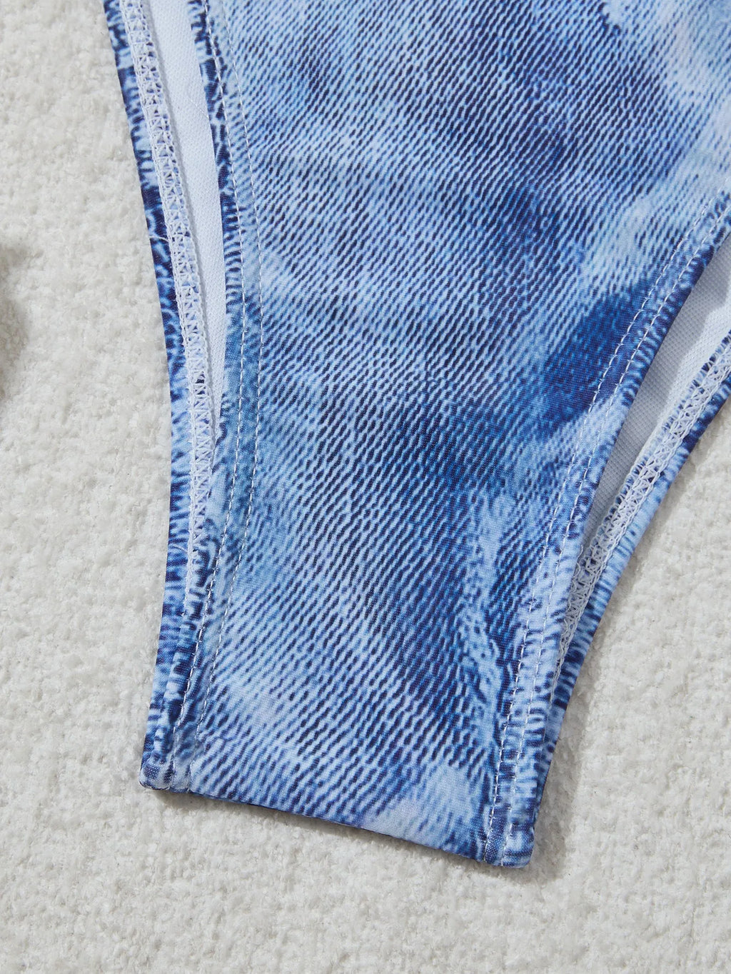 Women's denim blue printed bikini set with strap design, shown as a two-piece swimsuit.