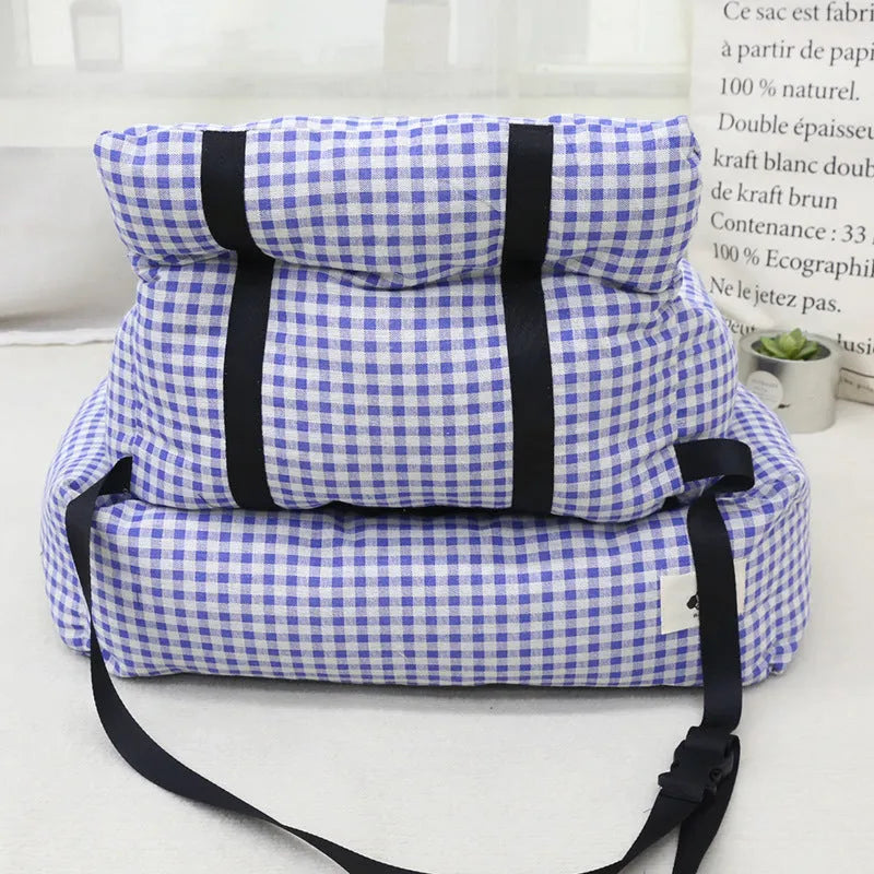 Grey and blue plaid car-mounted removable pet travel nest for dogs on a car seat