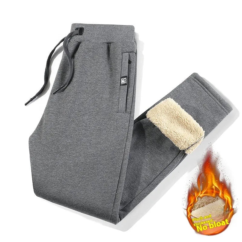 Men's grey fleece-lined oversized cotton track pants with a straight leg, shown on a hanger.