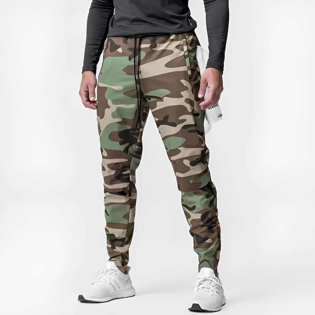 Men's grey quick-dry fitness trousers with ankle-tied design on exercise equipment