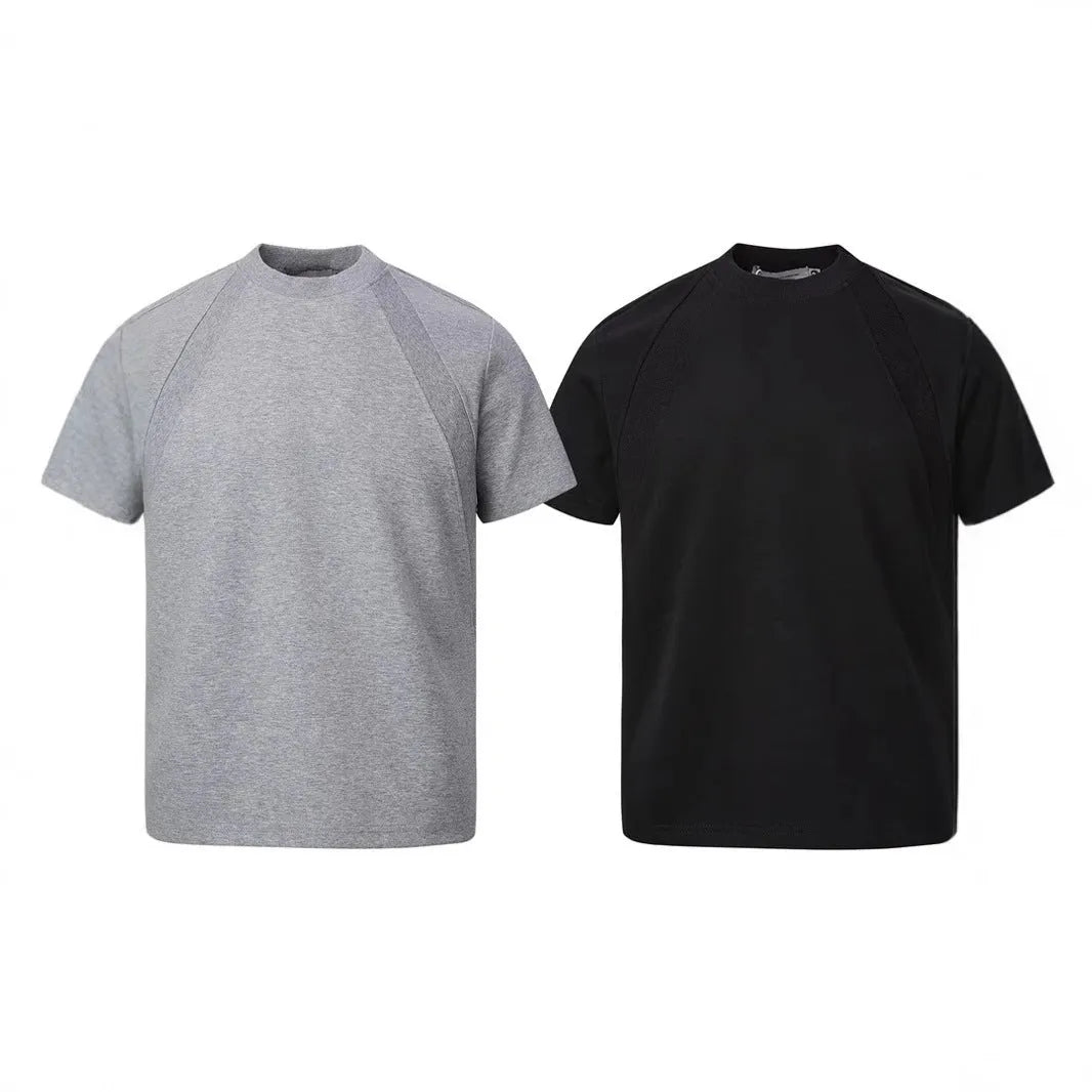 Men's black loose-fit short sleeve top with textured air layer stitching detail.