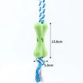 Red porous bone rope knot dog toy with treat-holding centre on white background