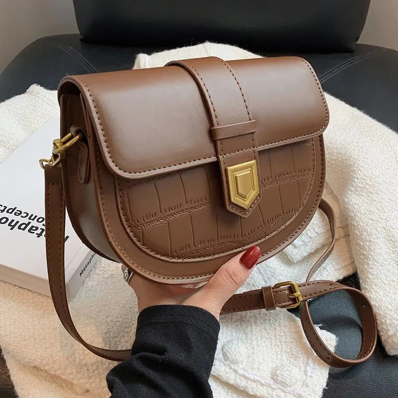 French one shoulder saddle bag in medium-soft PU with lock and stone pattern, available in black, brown, beige, and coffee