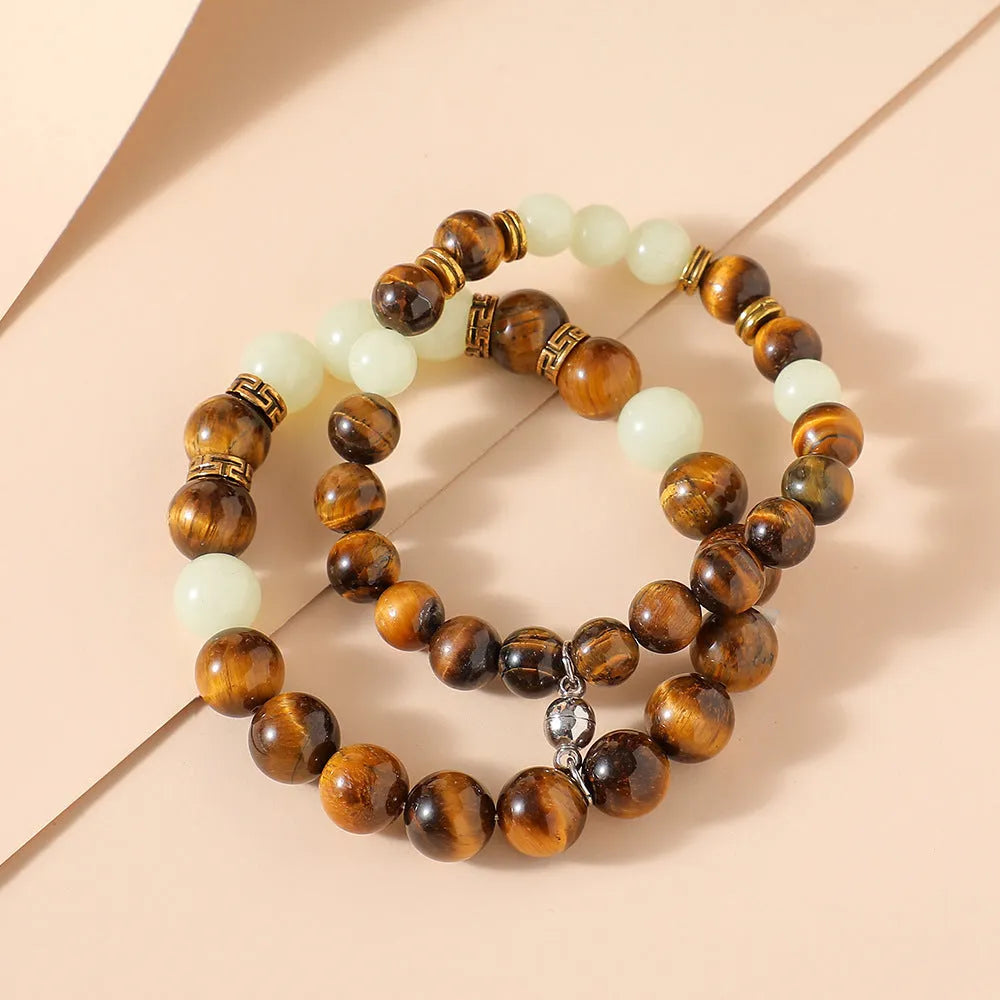 Pair of amber Y552 geometric luminous couple bracelets with patterned surface