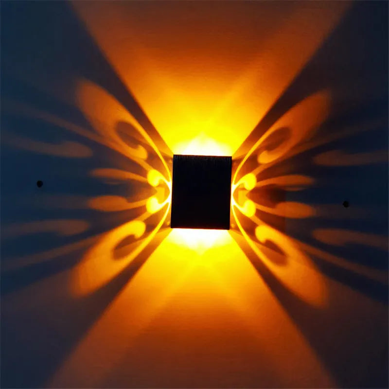 Modern silver aluminium butterfly-shaped LED wall lamp with multi-colour light options.