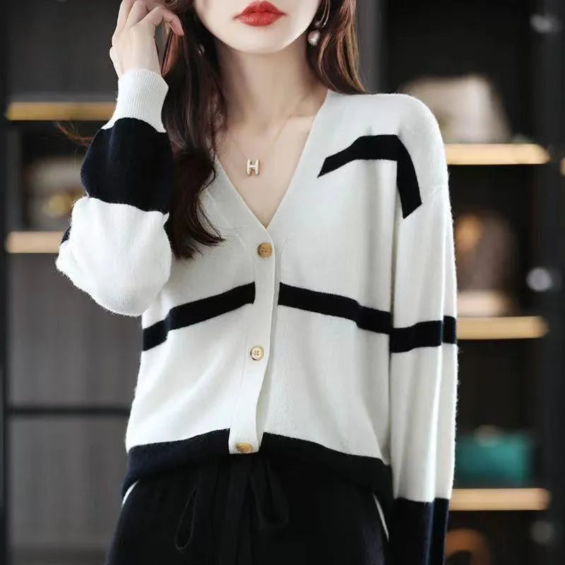 Women's black and white 3D striped knitted cardigan with button front and V-neck on a slim fit.