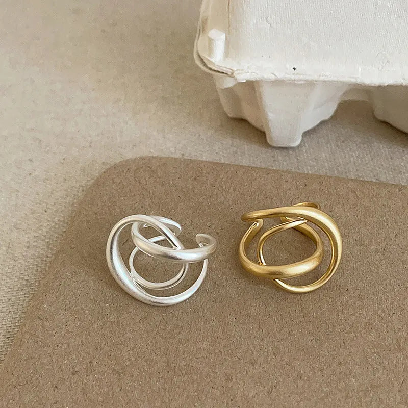 Geometric open ring with three-dimensional interlaced design in matte metal
