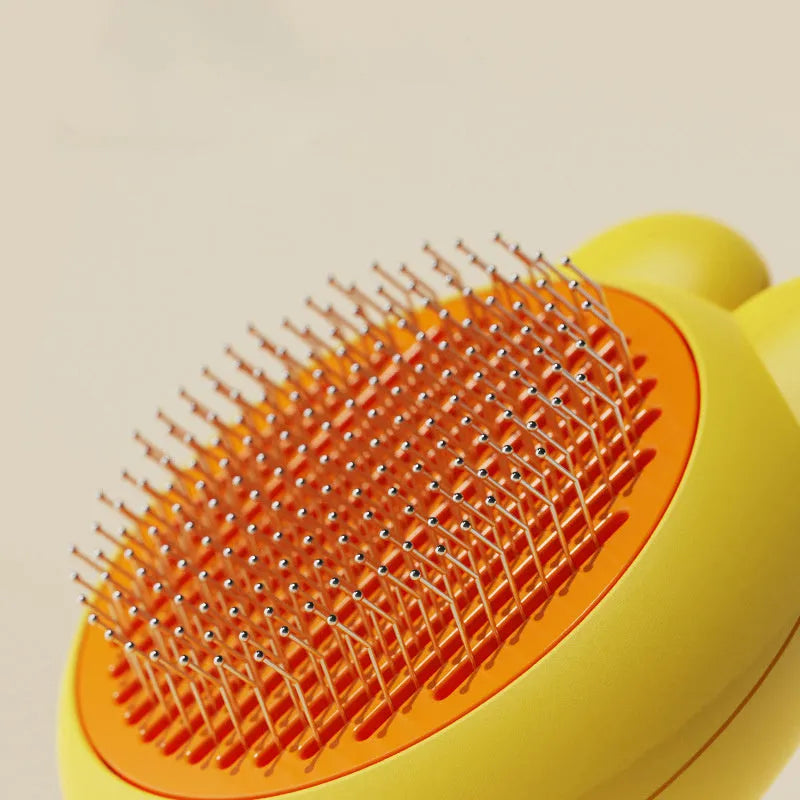 Green self-cleaning pet brush with metal comb and release button on a non-slip handle.