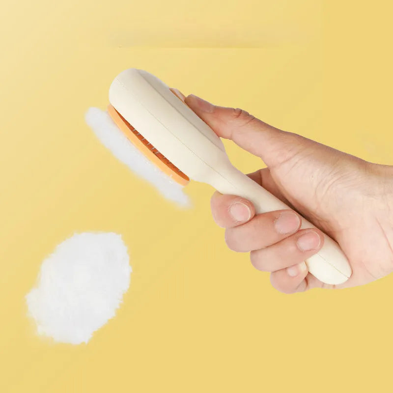 Green and yellow handled stainless steel pet grooming brush for cats and dogs on a white background.