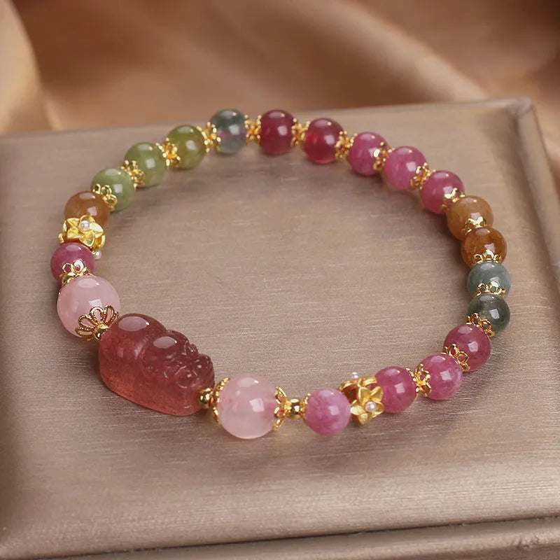 Pink crystal Pi Xiu bracelet with tourmaline and strawberry quartz beads on white background