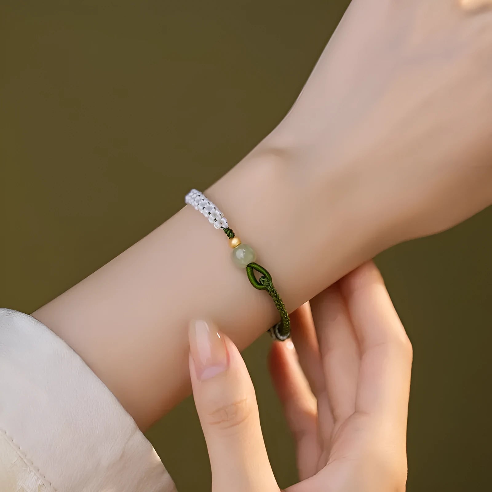 Chinese bracelet with Hetian Jade bead, sterling silver fittings, and adjustable coloured cord strap