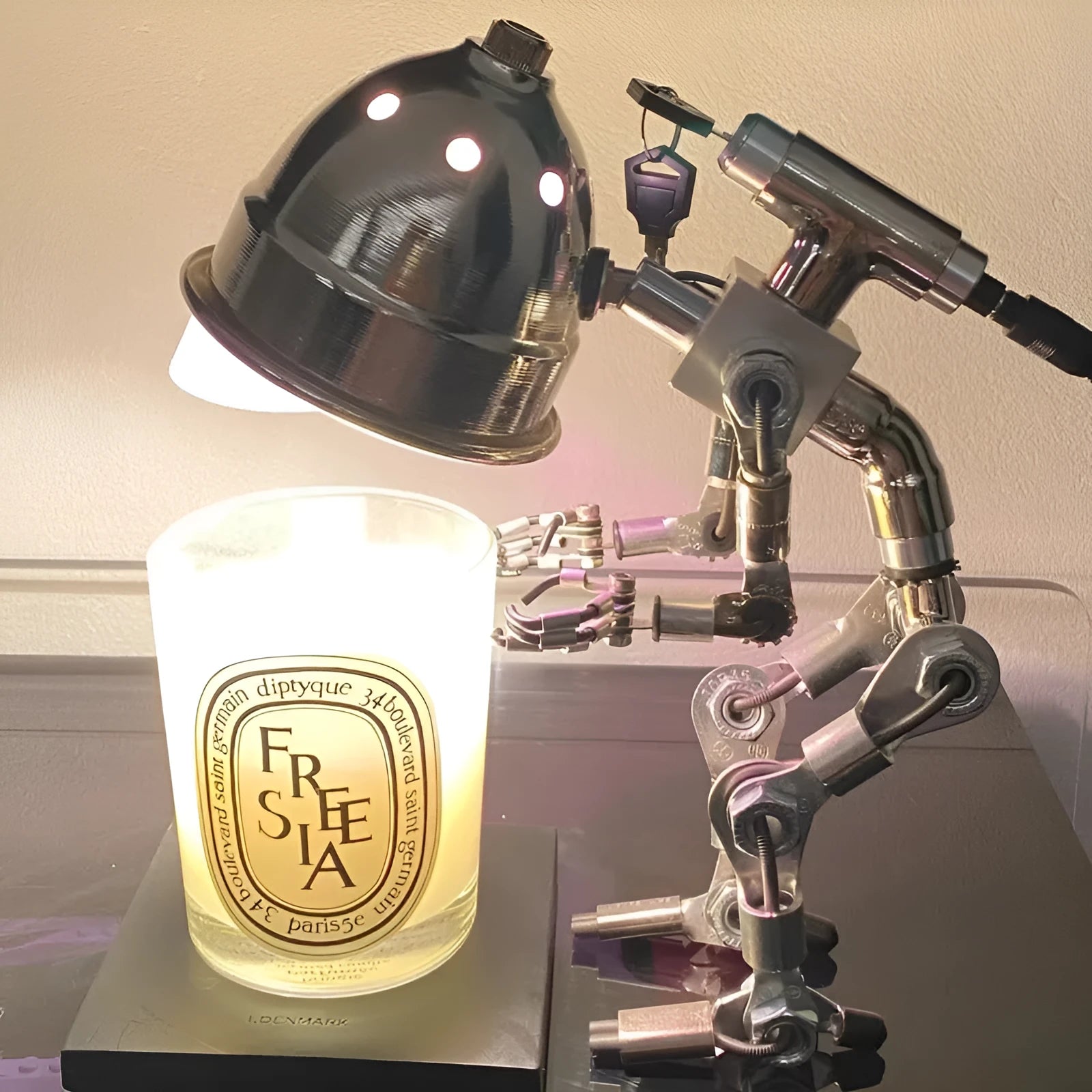 Robot-shaped desk lamp with custom graphic printing in silver or copper finish