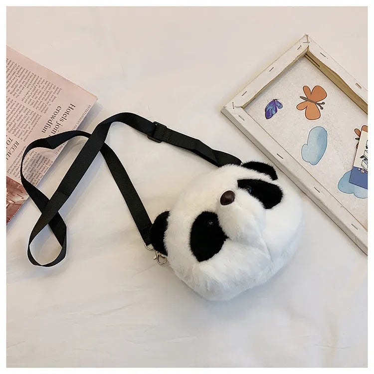 Soft plush crossbody bag with panda head design, cylindrical shape, and outer pocket.
