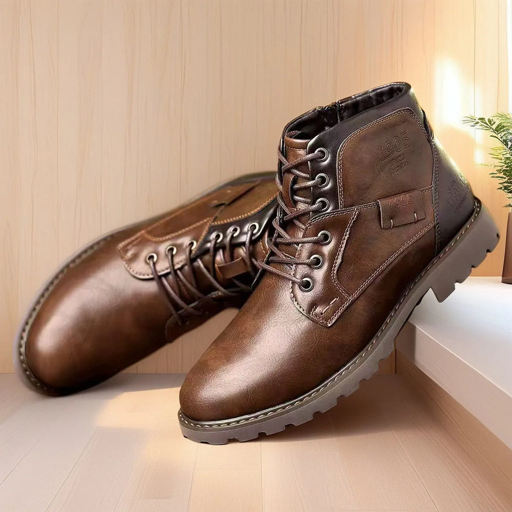 Men's black martin ankle boots with side zip, round toe, and rubber sole on a neutral background