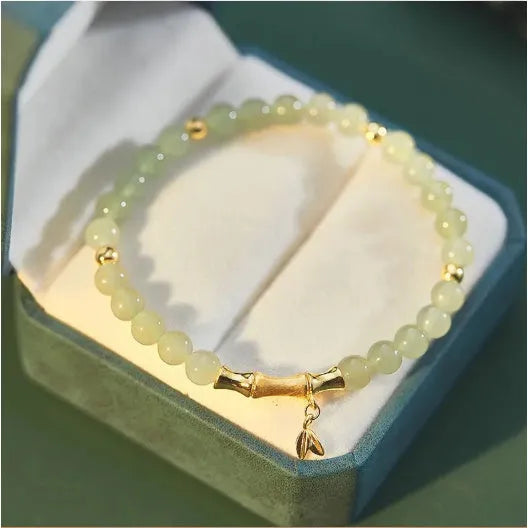 Bamboo special-design glass bracelet in beige with flower shape and Ruyi element, electroplated finish