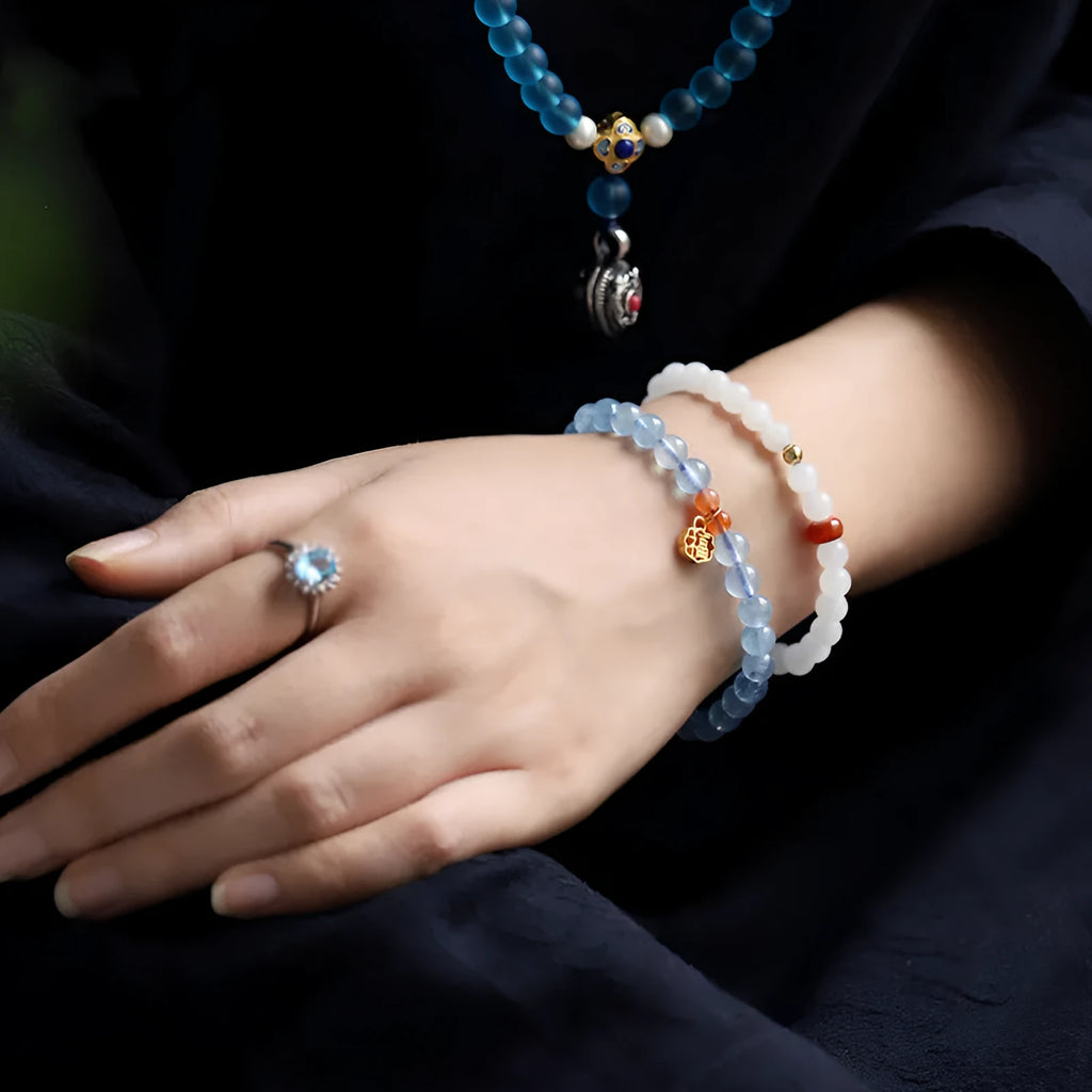 Natural ice translucent 8mm round crystal bead bracelet with sequin accents on display