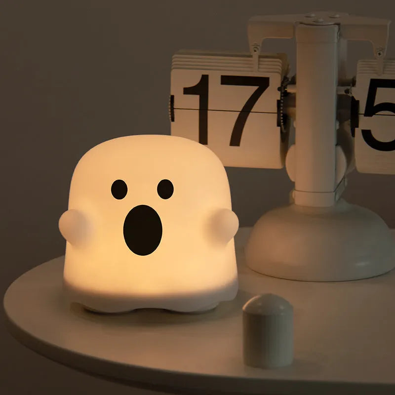Silicone night light in Ah Ah style on a bedside table with soft glow